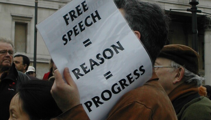 A protester against the information control law in the UK with a poster 